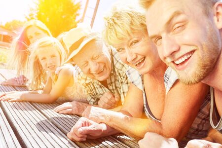 Extended family with children and grandparents together on summer vacationの写真素材