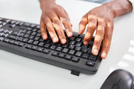 Hands are typing on computer keyboard as a concept for programming and development