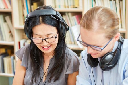Two women in a language class learn or work together as a freelance team