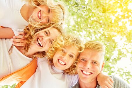 Family and kids are laughing happily in summerの写真素材