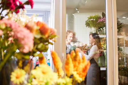 Two florists work as a team in the florist businessの写真素材