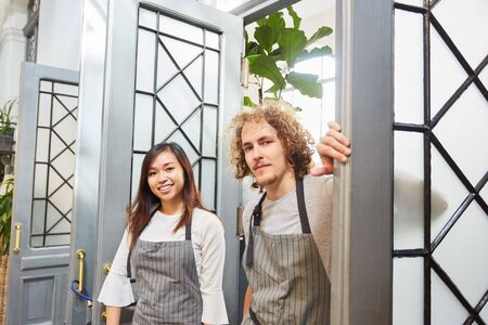 Two florists as a founder team in front of their garden center as a businessの写真素材