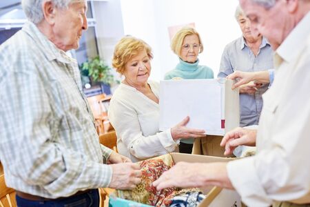 Voluntary seniors in a clothing donation campaign for the needy in the old people's home