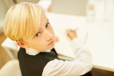 Boy as a trainee in the business office or as a student in class while learningの写真素材