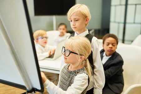 Children as business people work together in the project development workshop
