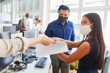 Start-up business team with mouth and nose protection because of Covid-19 during a planning or meetingの写真素材