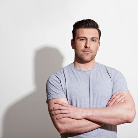 Attractive man is standing with his arms crossed