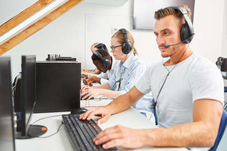 People using a headset as a member of a business hotline or as a student in a language courseの写真素材