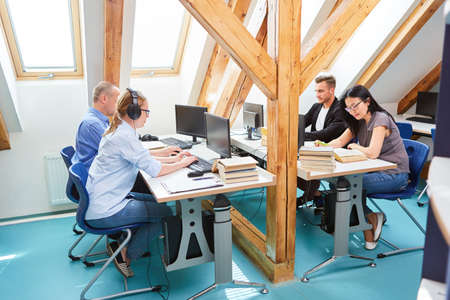 People work together in co-working office as a software developer on computers