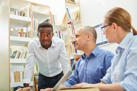 Multicultural team at a meeting or students in a workshopの写真素材