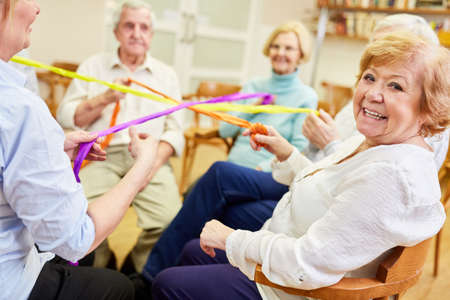 Group of seniors playing a game for team spirit and cohesion in the retirement home