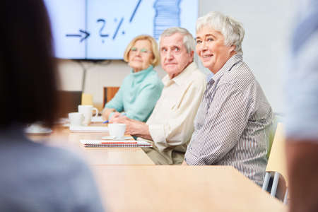 Group of seniors with financial advice on retirement provision and investment