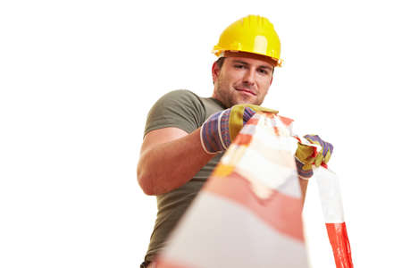 Construction worker blocks construction site with red and white barrier tape