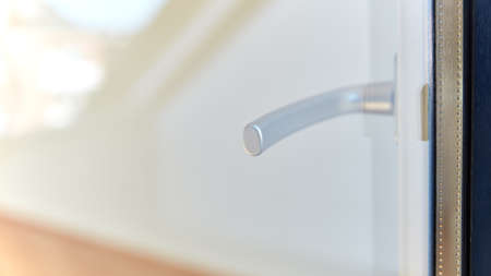 Doorknob through window on open door from outside of house to terraceの写真素材