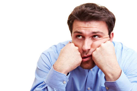 Frustrated manager is resting his head on his hands