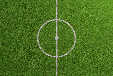 Centerline on grass of soccer and football field with center circle and kick-off point (3D rendering)の写真素材