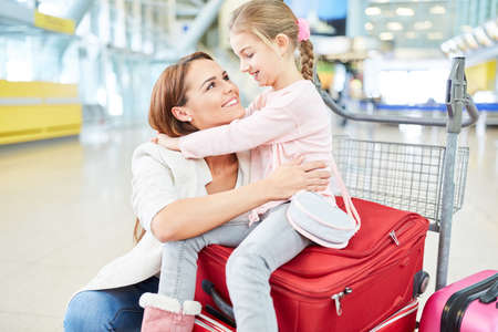Single mother and daughter in the airport terminal at the welcomeの写真素材