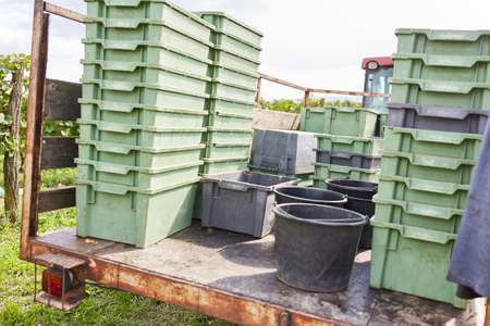 Stack of harvest boxes on the trailer while harvesting in the vineyard