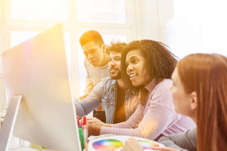 Web developers and web designers design websites together on the computer in the officeの写真素材