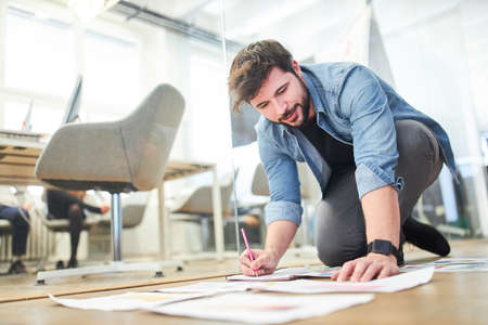 Graphic designer analyzes design concepts and print templates for a customer projectの写真素材