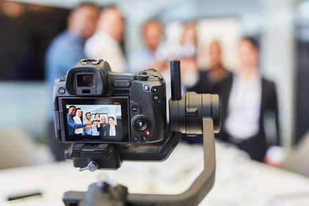 Video camera recording a company party for live streaming online