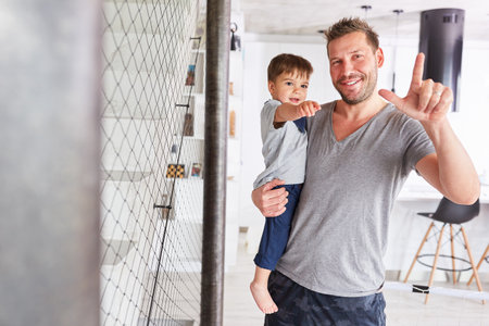Happy father carries his son in his arms for care and single parentingの写真素材