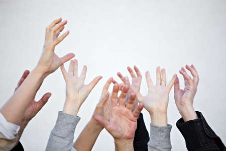 Many hands reach upの写真素材