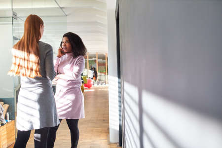 Two young business women or students as a team talking about feminism