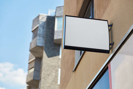 White Business Sign Mock-Up Template on City Buildingsの写真素材