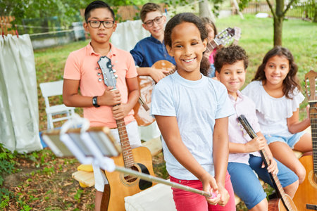 Children's music band takes a selfie before performing on the holiday camp talent showの写真素材