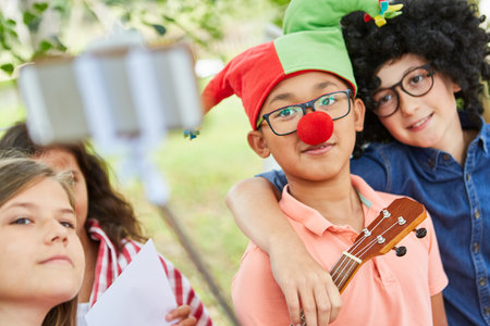 Children take a selfie at the talent show in funny disguise at the summer campの写真素材