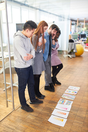 Graphic designer start-up team brainstorming the color design of a websiteの写真素材