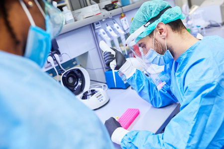 Two biotechnology researchers work together in the laboratory on Covid-19 vaccine for coronavirus...