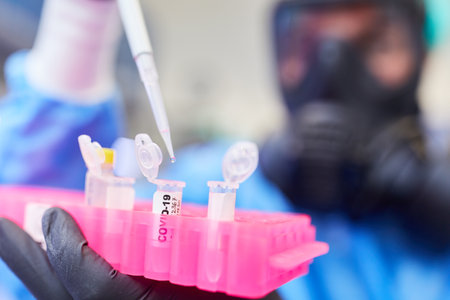 Chemists in the laboratory at Covid-19 vaccine research with pipette and ampoule