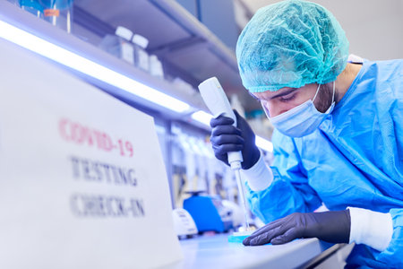Medic in the laboratory makes Covid-19 rapid test evaluation in case of coronavirus pandemic