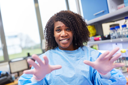 African woman as a researcher in the biotech laboratory during the coronavirus pandemic