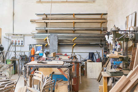 Workshop of a joinery or joinery with workbench and many materials