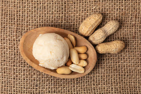 Fresh scoop of peanut ice cream or peanut butter rice with peanuts from above