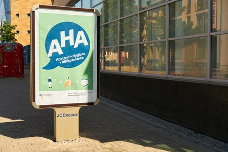 WARNEMUENDE, Germany, July 2020: Billdboard with German AHA (Distance, Hygiene, Alltagsmaske) rules (meaning distancing, hygiene, face mask) against spreading of Coronavirus and Covid-19のeditorial素材