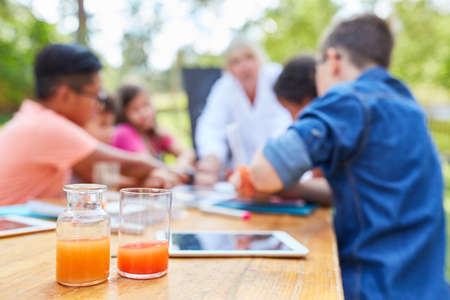 Teachers and children in chemistry tutoring lessons in summer camp vacation courseの写真素材