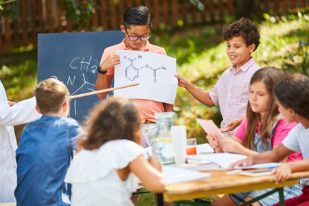 Group of children with a molecule drawing in summer tutoring chemistry courseの写真素材