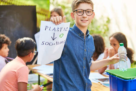 Children learn about plastic waste and environmental protection during a recycling project at the holiday campの写真素材