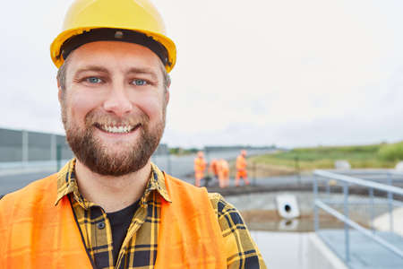 Smiling construction worker as a proud road builder on a construction site in the new development areaの写真素材