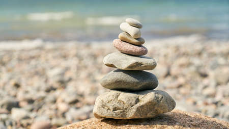 High pile of stones as Zen Buddhism meditation concept on the beach by the sea