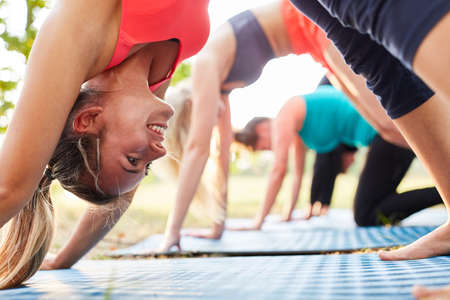 Young woman trains the healthy bend for the back in the wellness yoga class