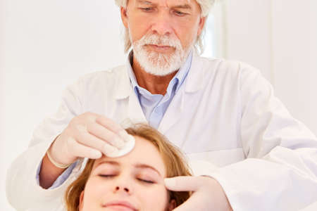 Beautician or dermatologist with professional skin cleaning in the dermatologist's practiceの写真素材
