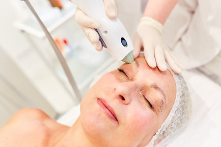 Elderly woman getting professional eyelid lift by Thermage in beauty clinicの写真素材