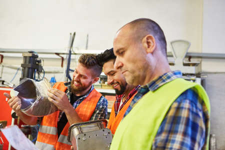 Specialist warehouse clerk and warehouse worker work together in shipping or material deliveryの写真素材