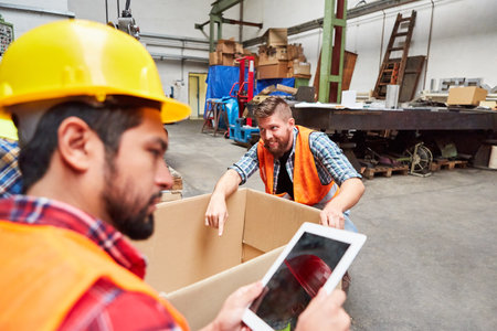 Specialist warehouse clerk checks incoming goods on the tablet computer in the shipping company's...
