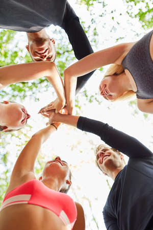 Group of friends in team building class giving the high five for motivation and team spiritの写真素材